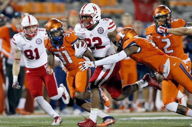 Nebraska running back Devine Ozigbo (22) carries as Illinois defensive back Cameron Watkins (31), linebacker Julian Jones (2) and defensive back Stanley Green, right front, pursue during the second half of an NCAA college football game Friday, Sept. 29, 2017, in Champaign, Ill. Nebraska won 28-6. (AP Photo/Stephen Haas)