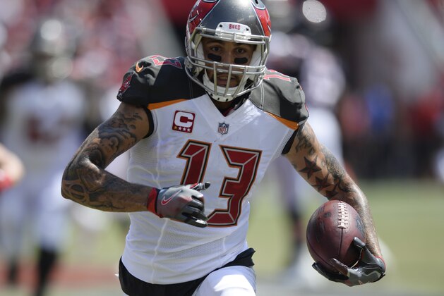 Tampa Bay Buccaneers wide receiver Mike Evans (13) tuns the ball, during the first half of an NFL football game against the Chicago Bears, Sunday, Sept. 17, 2017, in Tampa, Fla. (AP Photo/Jason Behnken)