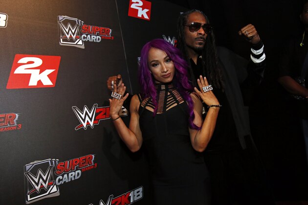 IMAGE DISTRIBUTED FOR 2K GAMES - WWE Superstar Sasha Banks and DJ Snoopadelic A.K.A Snoop Dogg are seen at the WWE 2K18 SummerSlam Kickoff Event on Friday, Aug. 18, 2017, in New York. (Photo by Adam Hunger/Invision for 2K Games/AP Images)