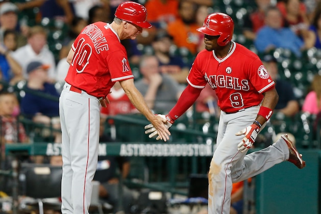 HOUSTON, TX - SEPTEMBER 24:  Justin Upton #9 of the Los Angeles Angels of Anaheim receives congratulations from third base coach Ron Roenicke #10 after hitting a home run in the eighth inning against the Houston Astros at Minute Maid Park on September 24, 2017 in Houston, Texas.  (Photo by Bob Levey/Getty Images)