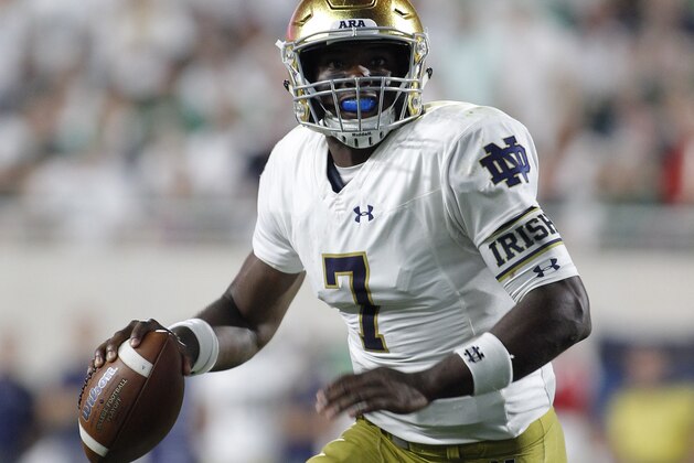 Notre Dame quarterback Brandon Wimbush rolls out before throwing a touchdown pass against Michigan State during the second quarter of an NCAA college football game, Saturday, Sept. 23, 2017, in East Lansing, Mich. (AP Photo/Al Goldis)