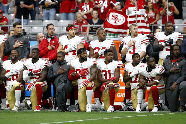 Members of the San Francisco 49ers kneel as others stand during the national anthem prior to an NFL football game against the Arizona Cardinals, Sunday, Oct. 1, 2017, in Glendale, Ariz. (AP Photo/Ross D. Franklin)