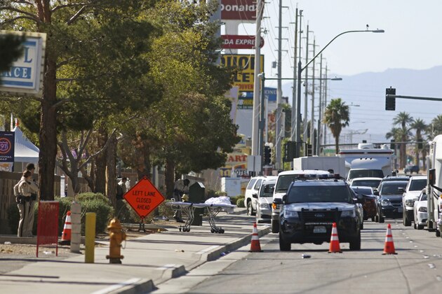 Law enforcement work outside the site of the Route 91 Harvest concert venue on the Las Vegas Strip Monday, Oct. 2, 2017, in Las Vegas. A mass shooting occurred late night Sunday at the music festival. (AP Photo/Ronda Churchill)