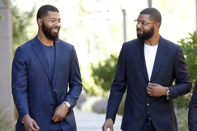 FILE in this Sept. 19, 2017 file photo, NBA players Markieff, left, and Marcus Morris arrive at Superior Court for the second day of their aggravated assault trial in Phoenix.  Jurors are expected to hear closing arguments Thursday, Sept. 28,  for the assault trial of the NBA players.  The Morris brothers are accused of helping three other people beat Erik Hood on Jan. 24, 2015. (AP Photo/Matt York, File)