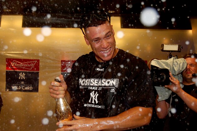 NEW YORK, NY - OCTOBER 03:  Aaron Judge #99 of the New York Yankees celebrates in the clubhouse after defeated the Minnesota Twins during the American League Wild Card Game at Yankee Stadium on October 3, 2017 in the Bronx borough of New York City.  (Photo by Elsa/Getty Images)