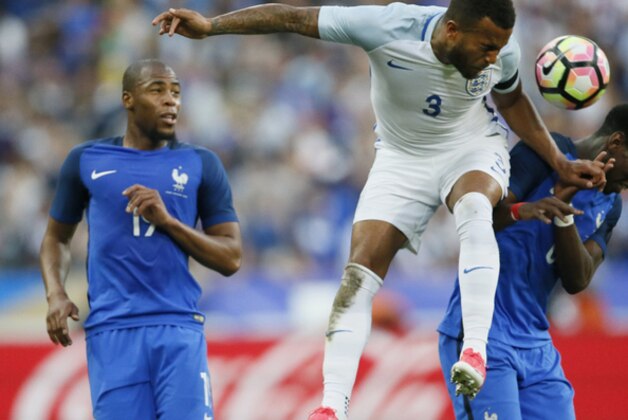 England's Ryan Bertrand, center, challenges France's Paul Pogba while France's Djibril Sidibe, left, looks on during a friendly soccer match between France and England at the Stade de France in Saint Denis, north of Paris, France, Tuesday, June 13, 2017. (AP Photo/Francois Mori)