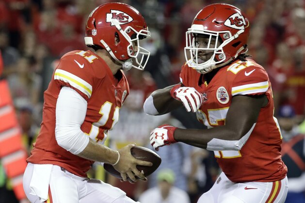 Kansas City Chiefs quarterback Alex Smith (11) fakes a handoff to running back Kareem Hunt during the first half of an NFL football game against the Washington Redskins in Kansas City, Mo., Monday, Oct. 2, 2017. (AP Photo/Charlie Riedel)