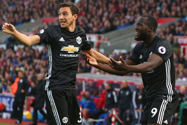 Manchester United's Belgian striker Romelu Lukaku (R) celebrates scoring their second goal with teammate Manchester United's Italian defender Matteo Darmian (L) during the English Premier League football match between Stoke City and Manchester United at the Bet365 Stadium in Stoke-on-Trent, central England on September 9, 2017. / AFP PHOTO / Geoff CADDICK / RESTRICTED TO EDITORIAL USE. No use with unauthorized audio, video, data, fixture lists, club/league logos or 'live' services. Online in-match use limited to 75 images, no video emulation. No use in betting, games or single club/league/player publications.  /         (Photo credit should read GEOFF CADDICK/AFP/Getty Images)