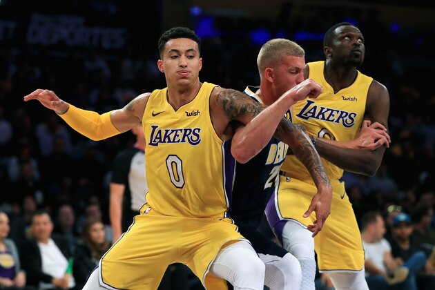 LOS ANGELES, CA - OCTOBER 02:  Kyle Kuzma #0 and Luol Deng #9 of the Los Angeles Lakers defend against Mason Plumlee #24 of the Denver Nuggets during the second half of a preseason game at Staples Center on October 2, 2017 in Los Angeles, California.  NOTE TO USER: User expressly acknowledges and agrees that, by downloading and or using this Photograph, user is consenting to the terms and conditions of the Getty Images License Agreement  (Photo by Sean M. Haffey/Getty Images)