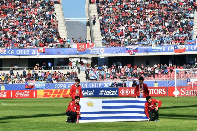 The Uruguayan flag is displayed during the 2015 Copa America football championship match between Uruguay and Paraguay, in La Serena, on June 20, 2015.  AFP PHOTO / YURI CORTEZ        (Photo credit should read YURI CORTEZ/AFP/Getty Images)
