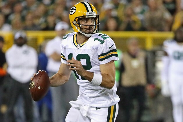 GREEN BAY, WI - SEPTEMBER 28:  Aaron Rodgers #12 of the Green Bay Packers rolls out to look for a receiver against the Chicago Bears at Lambeau Field on September 28, 2017 in Green Bay, Wisconsin. The Packers defeated the Bears 35-14.  (Photo by Jonathan Daniel/Getty Images)