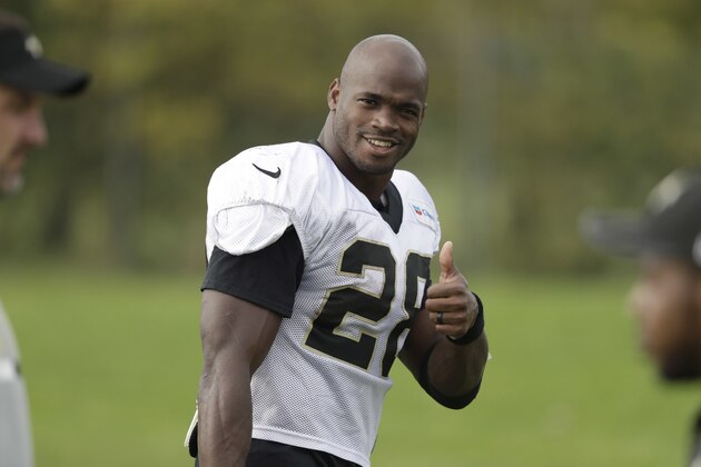 New Orleans Saints running back Adrian Peterson gives a thumbs-up to photographers as he walks off the field after taking part in an NFL training session at the London Irish rugby team training ground in the Sunbury-on-Thames suburb of south west London, Wednesday, Sept. 27, 2017. The New Orleans Saints are preparing for an NFL regular season game against the Miami Dolphins at London's Wembley stadium on Sunday. (AP Photo/Matt Dunham)