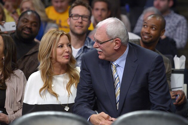 Jeanie Buss, left, Los Angeles Lakers executive vice president of business operations, and former Lakers head coach Phil Jackson sit during the first half of their NBA basketball game against the Dallas Mavericks, Tuesday, April 2, 2013, in Los Angeles. (AP Photo/Mark J. Terrill)