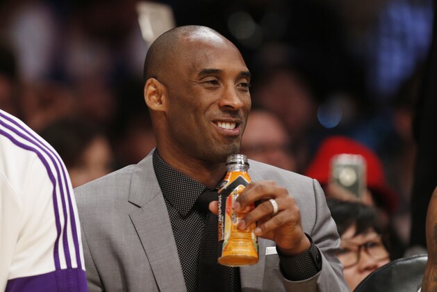 Los Angeles Lakers' Kobe Bryant, who is injured, drinks a BodyArmor Superdrink on the bench against the New York Knicks during an NBA Basketball game, Thursday, March 12, 2015, in Los Angeles. The Knicks won 101-94. Bryant is an investor in the upstart sports drink BODYARMOR. (AP Photo/Danny Moloshok)