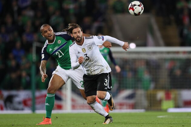BELFAST, NORTHERN IRELAND - OCTOBER 05:  Josh Magennis of Northern Ireland competes with Marvin Plattenhardt of Germany during the FIFA 2018 World Cup Qualifier between Northern Ireland and Germany at Windsor Park on October 5, 2017 in Belfast, Northern Ireland. (Photo by Matthew Ashton - AMA/Getty Images)