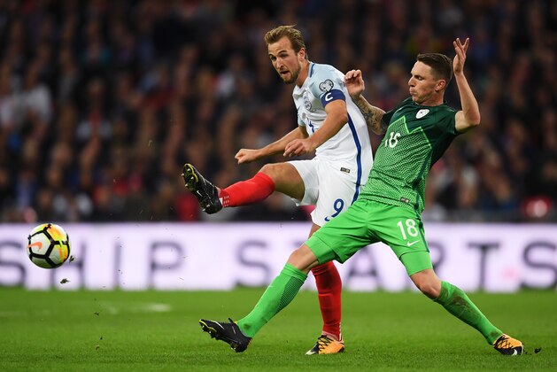 LONDON, ENGLAND - OCTOBER 05:  Harry Kane of England beats Rajko Rotman of Slovenia to the ball during the FIFA 2018 World Cup  Group F Qualifier between England and Slovenia at Wembley Stadium on October 5, 2017 in London, England.  (Photo by Laurence Griffiths/Getty Images)