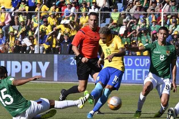 Brazil's Neymar (C) and Bolivia's Christian Machado (L) vie for the ball during their 2018 World Cup qualifier football match against Bolivia in La Paz on October 5, 2017. / AFP PHOTO / AIZAR RALDES        (Photo credit should read AIZAR RALDES/AFP/Getty Images)