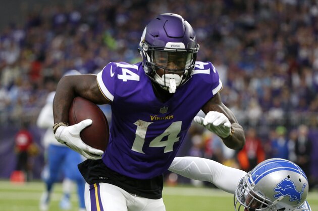 Minnesota Vikings wide receiver Stefon Diggs (14) runs from Detroit Lions free safety Glover Quin (27) after making a reception during the first half of an NFL football game, Sunday, Oct. 1, 2017, in Minneapolis. (AP Photo/Bruce Kluckhohn)