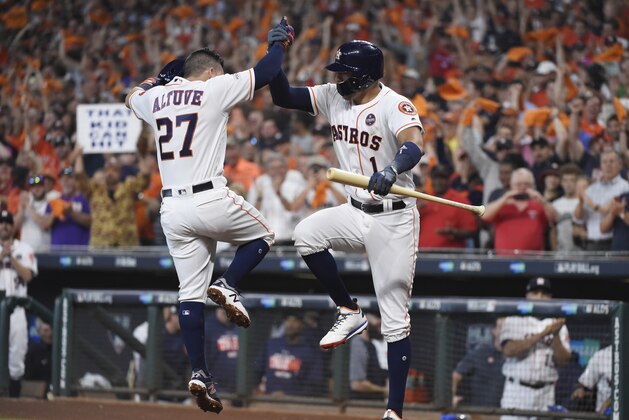 Houston Astros' Jose Altuve (27) celebrates his solo home run against the Boston Red Sox with teammate Carlos Correa (1) during the first inning in Game 1 of baseball's American League Division Series, Thursday, Oct. 5, 2017, in Houston. (AP Photo/Eric Christian Smith)