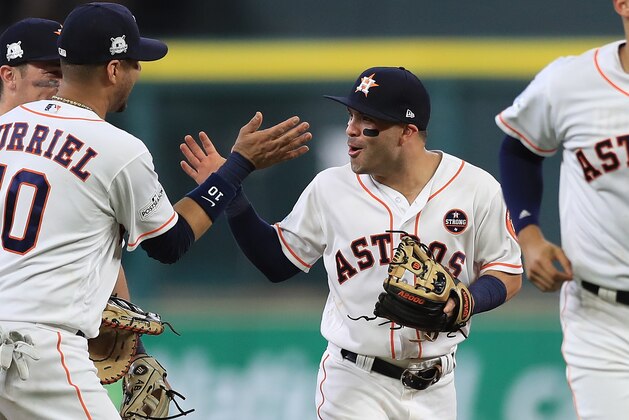 HOUSTON, TX - OCTOBER 05:  Jose Altuve #27 of the Houston Astros celebrates a 8-2 win with Yuli Gurriel #10 against the Boston Red Sox during game one of the American League Division Series at Minute Maid Park on October 5, 2017 in Houston, Texas.  (Photo by Ronald Martinez/Getty Images)