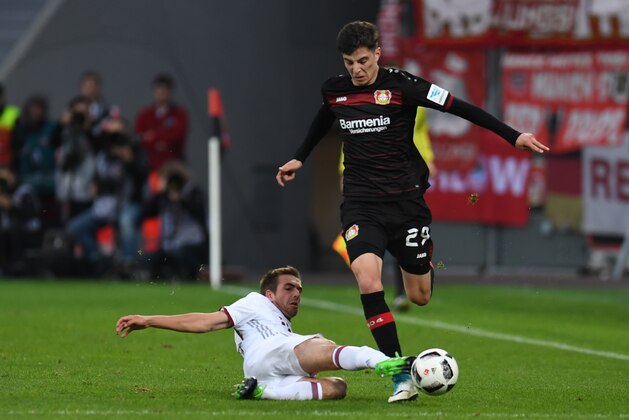 Bayern Munich's defender Philipp Lahm (L) and Leverkusen's midfielder Kai Havertz vie for the ball during the German First division Bundesliga football match between Bayer 04 Leverkusen and FC Bayern Munich in Leverkusen, on April 15, 2017. / AFP PHOTO / PATRIK STOLLARZ / RESTRICTIONS: DURING MATCH TIME: DFL RULES TO LIMIT THE ONLINE USAGE TO 15 PICTURES PER MATCH AND FORBID IMAGE SEQUENCES TO SIMULATE VIDEO. == RESTRICTED TO EDITORIAL USE == FOR FURTHER QUERIES PLEASE CONTACT DFL DIRECTLY AT + 49 69 650050
        (Photo credit should read PATRIK STOLLARZ/AFP/Getty Images)