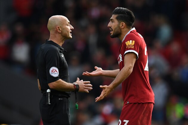 Liverpool's German midfielder Emre Can (R) appeals to referee Roger East during the English Premier League football match between Liverpool and Burnley at Anfield in Liverpool, north west England on September 16, 2017.
The game ended 1-1. / AFP PHOTO / Paul ELLIS / RESTRICTED TO EDITORIAL USE. No use with unauthorized audio, video, data, fixture lists, club/league logos or 'live' services. Online in-match use limited to 75 images, no video emulation. No use in betting, games or single club/league/player publications.  /         (Photo credit should read PAUL ELLIS/AFP/Getty Images)