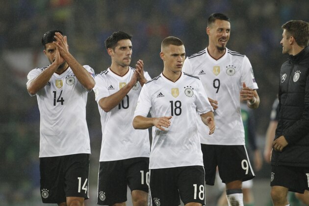Germany's, from left, Emre Can, Lars Stindl, Joshua Kimmich, Sandro Wagner and Thomas Mueller applaud their supporters after the World Cup Group C qualifying soccer match between Northern Ireland and Germany at Windsor Park in Belfast, Northern Ireland, Thursday, Oct. 5, 2017. (AP Photo/Peter Morrison)