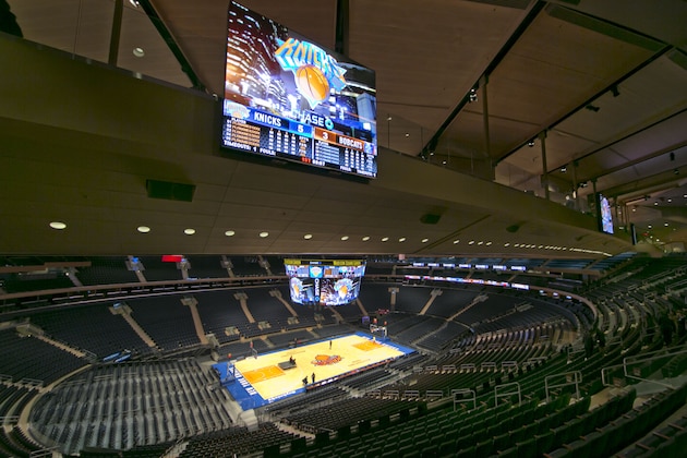 Members of the media walk across one of two bridges that span across the arena during a tour of the newly-renovated Madison Square Garden, Thursday, Oct. 24, 2013, in New York. After three years and $1 billion, there’s no shortage of luxury suites and premium seating, most notably in two “bridges” that fly high above the seating bowl near the arena’s familiar wagon-wheel ceiling.(AP Photo/Richard Drew)
