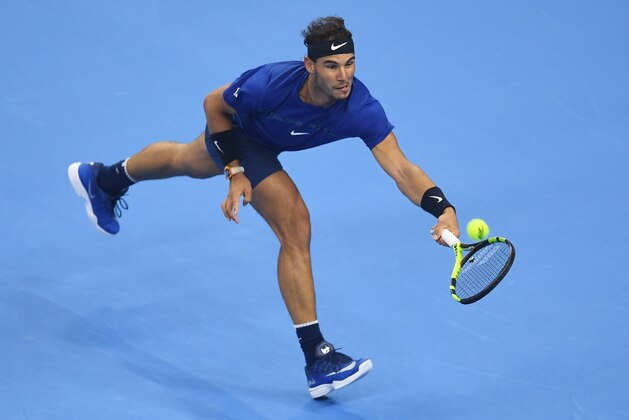 Rafael Nadal of Spain hits a return during his men's singles semi-final match against Grigor Dimitrov of Bulgaria at the China Open tennis tournament in Beijing on October 7, 2017 / AFP PHOTO / GREG BAKER        (Photo credit should read GREG BAKER/AFP/Getty Images)