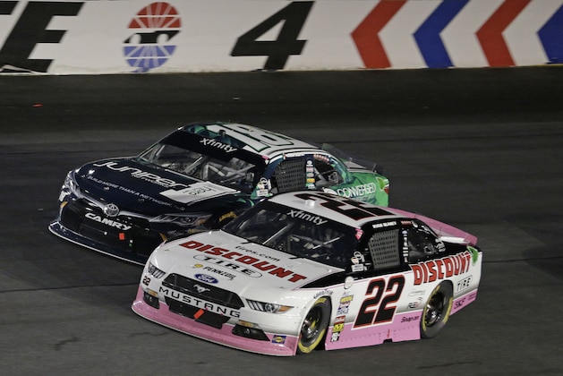 Ryan Blaney (22) races Daniel Suarez (18) out of Turn 4 during an Xfinity Series auto race at Charlotte Motor Speedway in Concord, N.C., Saturday, Oct. 7, 2017. (AP Photo/Chuck Burton)