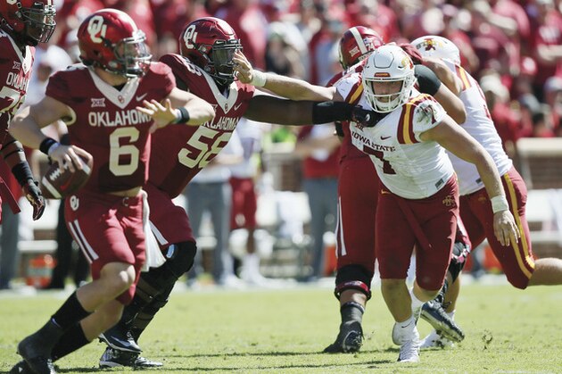 Iowa State quarterback Joel Lanning (7) is blocked by Oklahoma offensive lineman Erick Wren (58) as he chases quarterback Baker Mayfield (6) in the third quarter of an NCAA college football game in Norman, Okla., Saturday, Oct. 7, 2017. Iowa State won 38-31. (AP Photo/Sue Ogrocki)