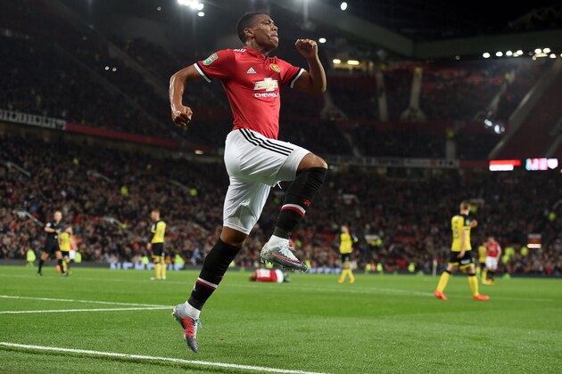 Manchester United's French striker Anthony Martial celebrates scoring his team's fourth goal during the English League Cup third round football match between Manchester United and Burton Albion at Old Trafford in Manchester on September 20, 2017. / AFP PHOTO / PAUL ELLIS / RESTRICTED TO EDITORIAL USE. No use with unauthorized audio, video, data, fixture lists, club/league logos or 'live' services. Online in-match use limited to 75 images, no video emulation. No use in betting, games or single club/league/player publications.  /         (Photo credit should read PAUL ELLIS/AFP/Getty Images)