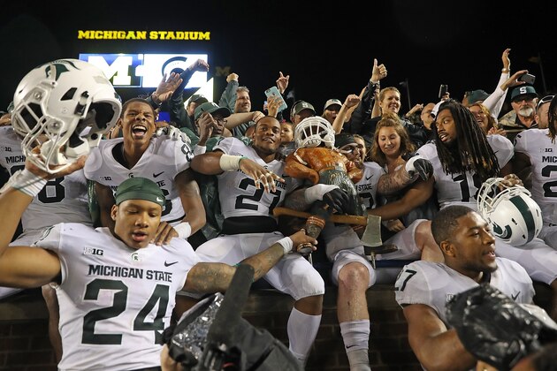 ANN ARBOR, MI - OCTOBER 07: Chris Frey #23 of Michigan State Spartans celebrate with his teammates a win over Michigan Wolverines with the Paul Banyun trophy at Michigan Stadium on October 7, 2017 in Ann Arbor, Michigan. Michigan State defeated Michigan 14-10. (Photo by Leon Halip/Getty Images)