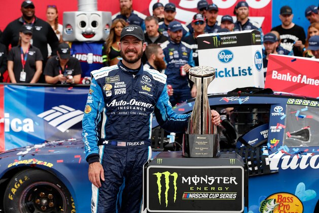 CHARLOTTE, NC - OCTOBER 08:  Martin Truex Jr., driver of the #78 Auto-Owners Insurance Toyota, poses with the trophy in Victory Lane after winning the Monster Energy NASCAR Cup Series Bank of America 500 at Charlotte Motor Speedway on October 8, 2017 in Charlotte, North Carolina.  (Photo by Brian Lawdermilk/Getty Images)