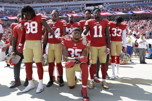 San Francisco 49ers safety Eric Reid (35) kneels during the national anthem in front of teammates before an NFL football game between the 49ers and the Carolina Panthers in Santa Clara, Calif., Sunday, Sept. 10, 2017. (AP Photo/Marcio Jose Sanchez)