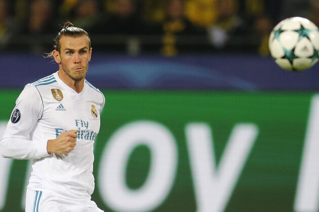 Real Madrid's Gareth Bale watches the ball go into the net as he scores his side's first goal during a Champions League Group H soccer match between Borussia Dortmund and Real Madrid at the BVB stadium in Dortmund, Germany, Tuesday, Sept. 26, 2017. (AP Photo/Michael Probst)
