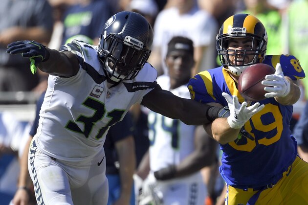 Seattle Seahawks strong safety Kam Chancellor, left, breaks up a pass intended for Los Angeles Rams tight end Tyler Higbee during the first half of an NFL football game Sunday, Oct. 8, 2017, in Los Angeles. (AP Photo/Mark J. Terrill)