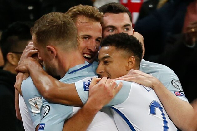 England's striker Harry Kane (2L) celebrates with team-mates after scoring the opening goal during the FIFA World Cup 2018 qualification football match between England and Slovenia at Wembley Stadium in London on October 5, 2017.  / AFP PHOTO / Ian KINGTON / NOT FOR MARKETING OR ADVERTISING USE / RESTRICTED TO EDITORIAL USE        (Photo credit should read IAN KINGTON/AFP/Getty Images)