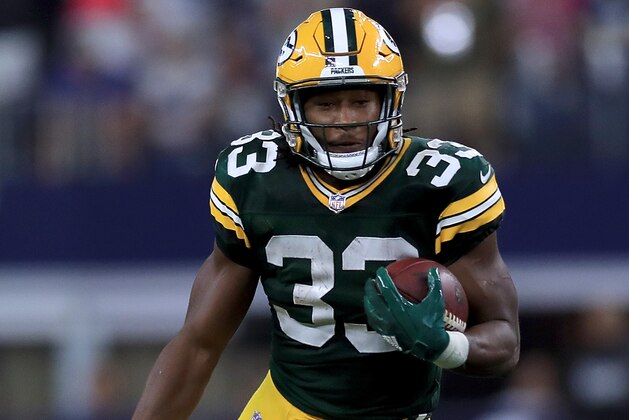 ARLINGTON, TX - OCTOBER 08:  Aaron Jones #33 of the Green Bay Packers runs the ball against the Dallas Cowboys in the fourth quarter at AT&T Stadium on October 8, 2017 in Arlington, Texas.  (Photo by Ronald Martinez/Getty Images)