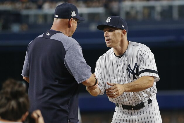 New York Yankees manager Joe Girardi, right, greets Cleveland Indians manager Terry Francona before Game 3 of an American League Division Series baseball game, Sunday, Oct. 8, 2017, in New York. (AP Photo/Kathy Willens)