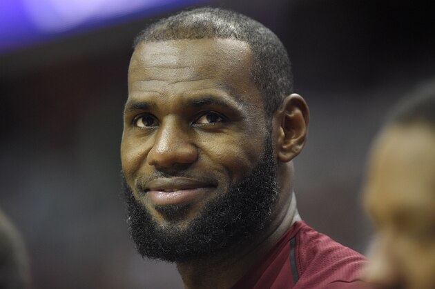 Cleveland Cavaliers forward LeBron James looks on from the bench during the first half of an preseason NBA basketball game against the Washington Wizards, Sunday, Oct. 8, 2017, in Washington. (AP Photo/Nick Wass)