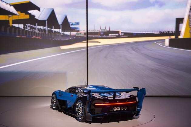 The Bugatti Vision Gran Turismo is presented on the backdrop of the playstation game with the same name at Volkswagen Group Night at the Fraport arena prior to the 66th IAA auto show in Frankfurt am Main, western Germany on September 14, 2015. Volkswagen group showed their latest models and automotive concepts from the brands Volkswagen, Audi, Bentley, Bugatti, Ducati, Lamborghini, Porsche, Seat and Skoda. Hundreds of thousands of visitors are expected to crowd into the massive exhibition halls of Frankfurt's sprawling trade fair grounds later this week to catch a glimpse of the latest models and high tech innovations. AFP PHOTO / ODD ANDERSEN (Photo credit should read ODD ANDERSEN/AFP/Getty Images) The Bugatti Vision Gran Turismo is presented on the backdrop of the playstation game with the same name at Volkswagen Group Night at the Fraport arena prior to the 66th IAA auto show in Frankfurt am Main, western Germany on September 14, 2015. Volkswagen group showed their latest models and automotive concepts from the brands Volkswagen, Audi, Bentley, Bugatti, Ducati, Lamborghini, Porsche, Seat and Skoda. Hundreds of thousands of visitors are expected to crowd into the massive exhibition halls of Frankfurt's sprawling trade fair grounds later this week to catch a glimpse of the latest models and high tech innovations. AFP PHOTO / ODD ANDERSEN (Photo credit should read ODD ANDERSEN/AFP/Getty Images)