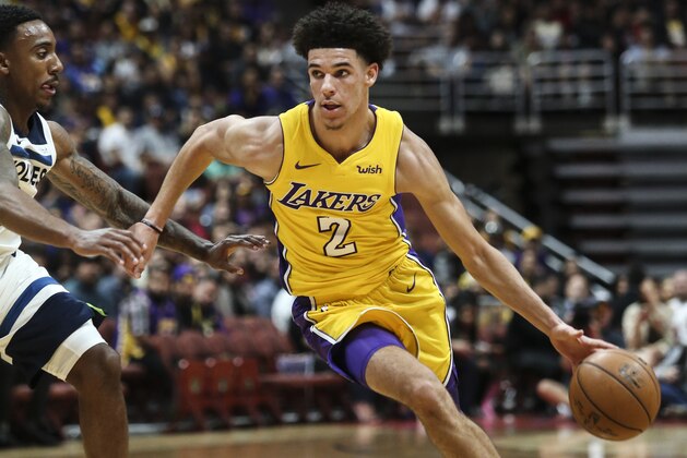 Los Angeles Lakers guard Lonzo Ball, right, drives against Minnesota Timberwolves guard Jeff Teague during the first half of an NBA preseason basketball game in Anaheim, Calif., Saturday, Sept. 30, 2017. (AP Photo/Ringo H.W. Chiu)