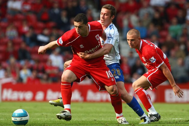 MIDDLESBROUGH, UNITED KINGDOM - MAY 03:  Fabio Rochemback of Middlesbrough is challenged by Sean Davis of Portsmouth during the Barclays Premier League Match between Middlesbrough and Portsmouth at Riverside Stadium on May 3, 2008 in Middlesbrough, England.  (Photo by Clive Rose/Getty Images)