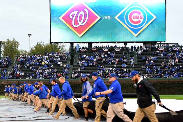 CHICAGO, IL - OCTOBER 10:  Members of the grounds crew cover the infield with a tarp before game four of the National League Division Series between the Washington Nationals and the Chicago Cubs at Wrigley Field on October 10, 2017 in Chicago, Illinois.  (Photo by Stacy Revere/Getty Images)