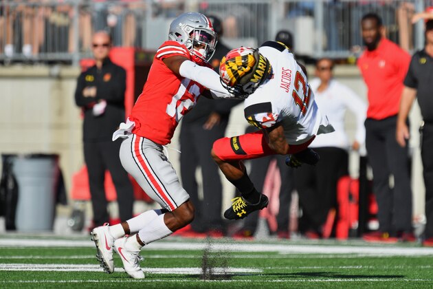 COLUMBUS, OH - OCTOBER 7:  Denzel Ward #12 of the Ohio State Buckeyes hits Taivon Jacobs #12 of the Maryland Terrapins after a reception in the first quarter at Ohio Stadium on October 7, 2017 in Columbus, Ohio. Ward was ejected from the game after being assessed a targeting penalty for the hit.  (Photo by Jamie Sabau/Getty Images)