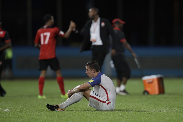 United States' Matt Besler, squats on the pitch after losing 2-1 against Trinidad and Tobago during a 2018 World Cup qualifying soccer match  in Couva, Trinidad, Tuesday, Oct. 10, 2017. (AP Photo/Rebecca Blackwell)