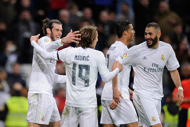 MADRID, SPAIN - MARCH 20:  Gareth Bale of Real Madrid celebrates with Luka Modric and Karim Benzema after scoring Real's 3rd goal during the La Liga match between Real Madrid CF and Sevilla FC at Estadio Santiago Bernabeu on March 20, 2016 in Madrid, Spain.  (Photo by Denis Doyle/Getty Images)