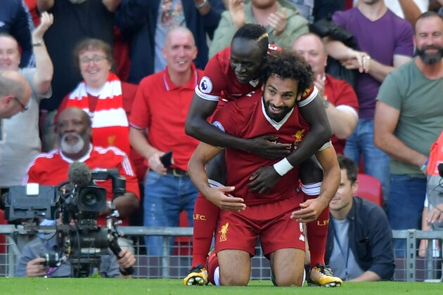 Liverpool's Egyptian midfielder Mohamed Salah (R) celebrates with Liverpool's Senegalese midfielder Sadio Mane after scoring their third goal during the English Premier League football match between Liverpool and Arsenal at Anfield in Liverpool, north west England on August 27, 2017. / AFP PHOTO / Anthony Devlin / RESTRICTED TO EDITORIAL USE. No use with unauthorized audio, video, data, fixture lists, club/league logos or 'live' services. Online in-match use limited to 75 images, no video emulation. No use in betting, games or single club/league/player publications.  /         (Photo credit should read ANTHONY DEVLIN/AFP/Getty Images)