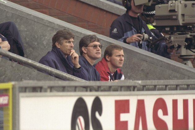 12 Oct 1996:  (left-right) Arsene Wenger the new Arsenal manager watches his first game in charge of his new club from visitors bench, alongside him are assistant manager Pat Rice and physio Gary Lewin  during the FA Carling Premier league match betweenBlackburn Rovers and Arsenal at Ewood Park in Blackburn. Arsenal went onto win the game by 0-2. Mandatory Credit: Shaun Botterill/Allsport